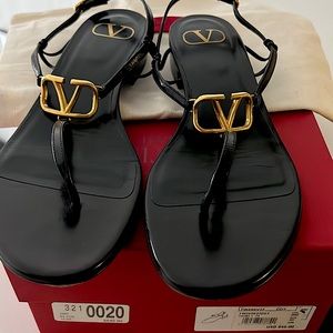 Valentino black thong sandals with gold V logo